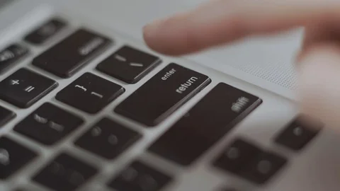 Closeup of the finger pressing enter button. Closeup of a female hand. Stock Footage 129267225