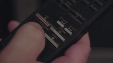 Closeup of a finger pressing the play button on a old remote TV control. Video stock 101498056