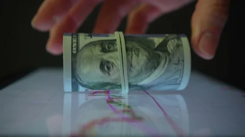 Closeup finger touching screen with diagram and put dollar bills on it. Vídeos de archivo 233841333
