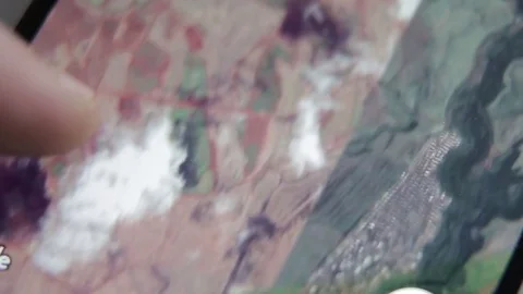 Closeup of finger touching a smartphone with a touch screen to scroll maps Stock Footage 70140869