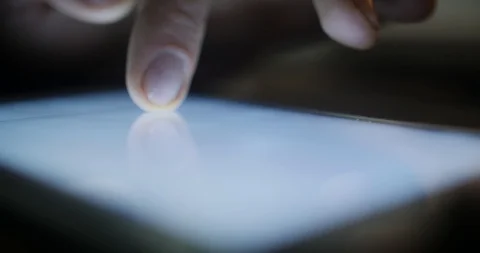 Closeup finger touching tablet computer touchscreen reading document Stock Footage 87324223