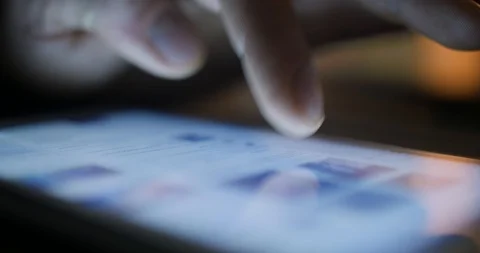 Closeup finger touching tablet computer touchscreen using social media Stock Footage