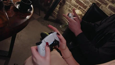 Closeup of fingers on controller within inviting cafe space Video stock 331885340