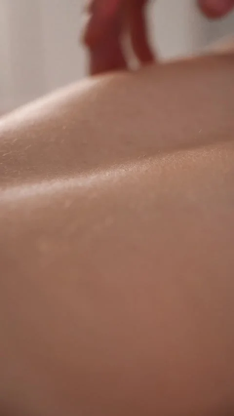 Closeup fingers gliding over back at end of massage Stock Footage 309203427