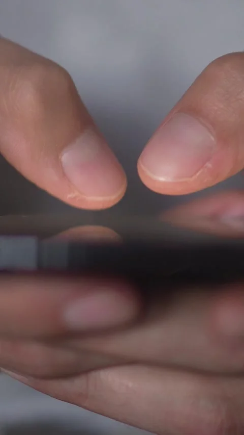 A closeup of fingers typing on a smartphone, utilizing technology for Stock Footage 284710892