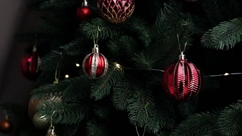 Closeup of fir tree with New Year decorations. Trendy red Christmas ornaments. Stock Footage 211353653