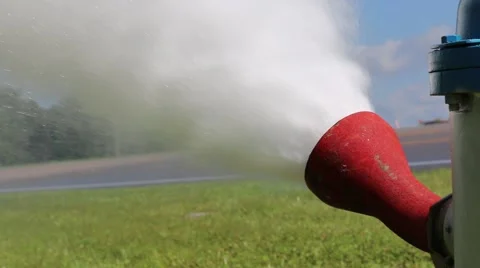 Closeup of Fire Hydrant Flushing with Cars Passing in Background Stock Footage 52888906