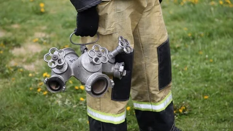 Closeup of a firefighter standing holding fire and branching Stock Footage 123988469