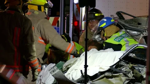 Closeup of fireman and paramedic working at car crash Video stock 70798057