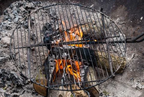 Closeup of firewood burning in fire cooking place outside Stock Photos