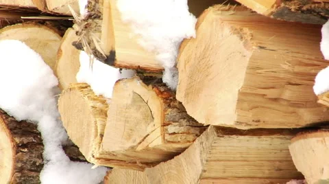 Closeup of firewood with snow falling Stock Footage 994325