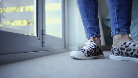 Closeup floor level: Low top canvas shoes with funky nature pattern Stock Footage 305134178