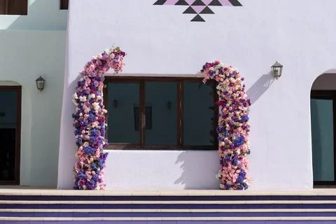 Closeup of Flower Frames on Lavender Building with Geometric Pattern  Stock Photos
