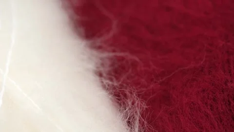 Closeup fluffy natural wool red and white for knitting and crocheting, rotation. Stock Footage 252632571