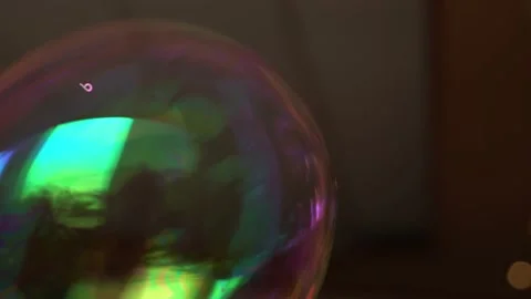 Closeup following a big rainbow colored soap and water bubble made by a funny 库存影片 167293231
