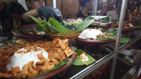 Closeup of Food Display Case with Server Preparing a Plate at Bali Warung Stock Footage 340271049