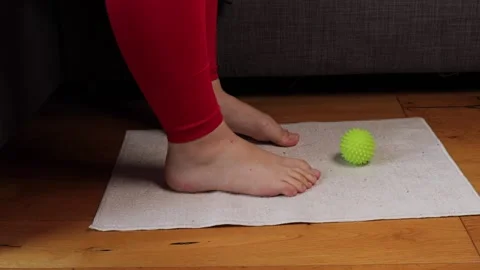 Closeup of foot gently moving over massage ball, foot action improving comf.. Video stock 320956760
