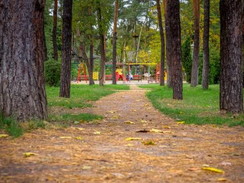Closeup of a foot path going to the public colorful kids playground and rope Stock Photos