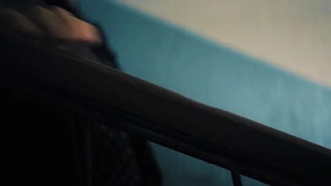 Closeup footage of elderly lady goes down stairs and holds on to a railing Stock Footage 87181777