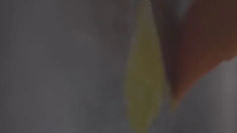 Closeup footage of spreading the melted ghee on a stainless baking tray with a Stock Footage 276794464