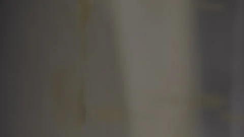 Closeup footage of spreading the melted ghee on a stainless baking tray with an Stock Footage 276794486