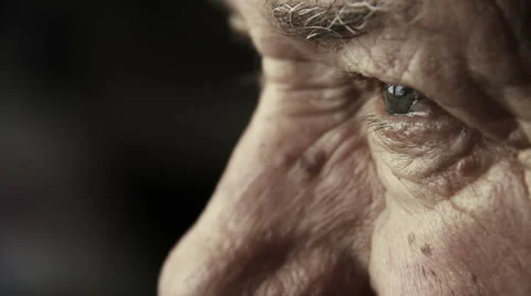 Closeup footage on very old man's eyes: thoughtful elderly man Stock Footage