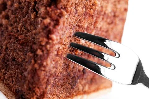 Closeup of a fork in a chocolate cake Stock Photos