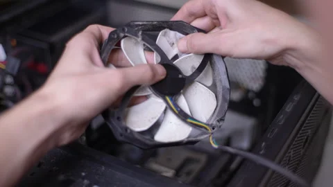 Closeup FPV view of unrecognizable man cleaning blades on dusty fan that cooling Stock Footage 233698278