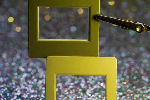 Closeup of frames with glitter and bokeh lights in the background Stock Photos