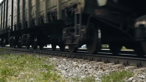 Closeup of freight train wheels passing by Stock Footage 111690973