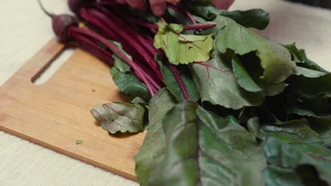 Closeup of fresh beetroots on a cutting board.  Video stock 310203712