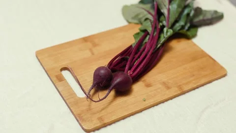 Closeup of fresh beetroots on a cutting board.  Video stock 310204102