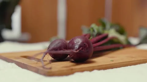 Closeup of fresh beetroots on a cutting board.  Video stock 310204903