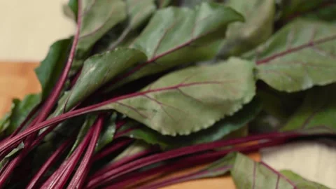 Closeup of fresh beetroots on a cutting board.  Video stock 310205231