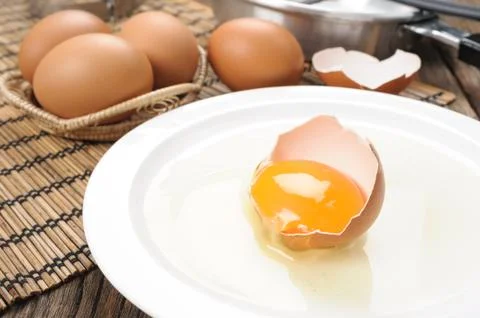 Closeup fresh egg isolate on white plate Stock Photos