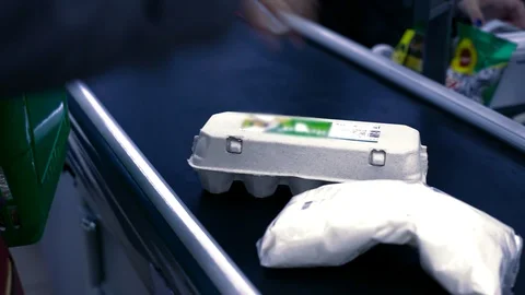 Closeup fresh eggs and white bag with food at cashier desk Stock Footage 100247950