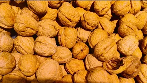 Closeup of fresh golden walnuts cascading in a mesmerizing food presentation, Stockbeeldmateriaal 318311005