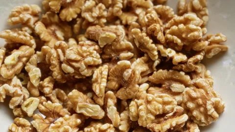 Closeup of fresh, healthy walnuts in a light-colored bowl, showing textured.. Stock Footage 293866279