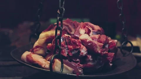 A closeup of fresh meat is being weighed on an old hanging weighing scale i.. Stock-Footage 245830431
