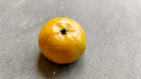 Closeup of a fresh orange fruit with vibrant orange color, showcasing natural  Stock Footage 336666704