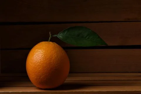 Closeup of a fresh picked navel orange in a wood packing crate. Stock Photos