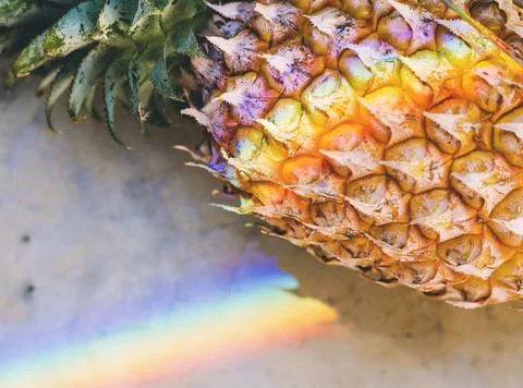 Closeup of fresh pineapple with rainbow prism light Stock Photos