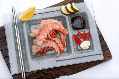 Closeup of a fresh prawns on a rectangular plate with wasabi dressings cheese pi Stock Photos