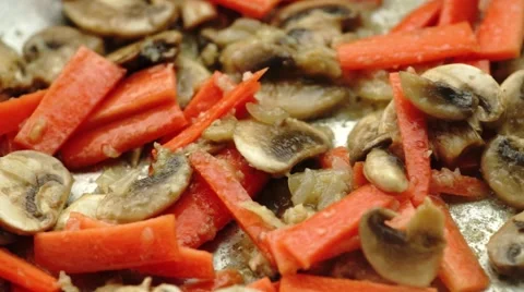 Closeup of fresh raw chilies added to sizzling pan of mushrooms in onion and  Stock Footage 68936637