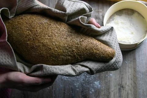 Closeup of fresh rustsic bread in a woman's hand Stock Photos