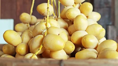 Closeup of Fresh Yellow Date Palm Fruits on Stems. Stock Footage 340456182