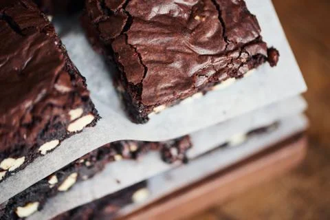 Closeup of a freshly baked stack of nutty chocolate brownies Stock Photos