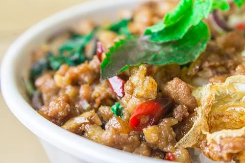 Closeup. fried rice with basil, minced pork and fried egg in a white cup, pla Stock Photos