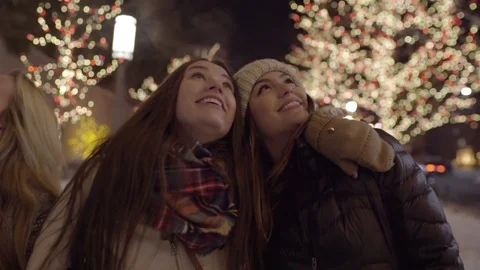 Closeup Of Friends Walking, Enjoying Christmas Lights, Look Up, Laugh And Smile Stock Footage