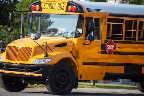 Closeup of front end of a schoolbus on a sunny day Stock Photos